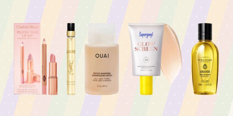 Mini beauty products from Charlotte Tilbury, Yves Saint Laurent, Ouai, Supergoop! and L’Occitane displayed against a pastel striped background.